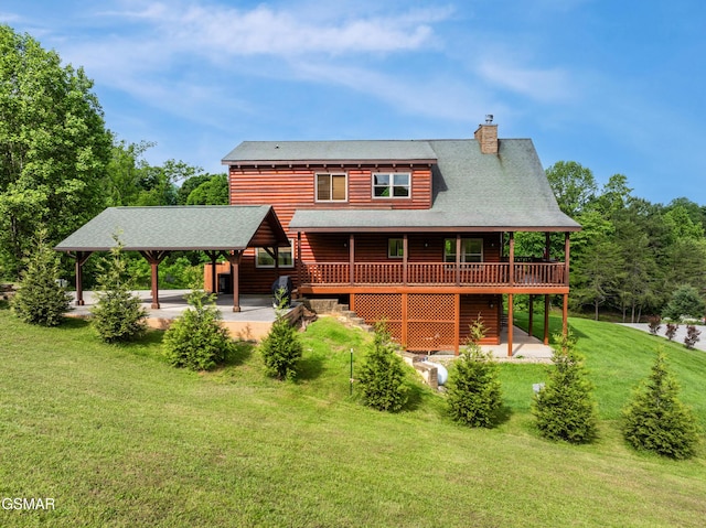 3391 Clear Valley Dr, Sevierville, TN 37862 - back of property with a yard, a chimney, a deck, and a patio area