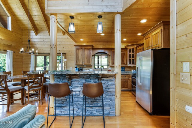 3391 Clear Valley Dr, Sevierville, TN 37862 - kitchen featuring stainless steel refrigerator with ice dispenser, wood ceiling, brown cabinetry, light wood-type flooring, and plenty of natural light