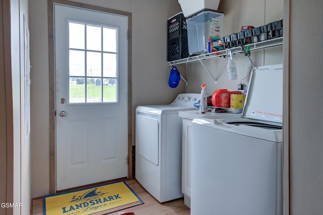 washroom with washer and dryer and light wood-type flooring