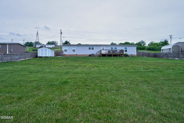 view of yard featuring a storage unit, a deck, and an outbuilding