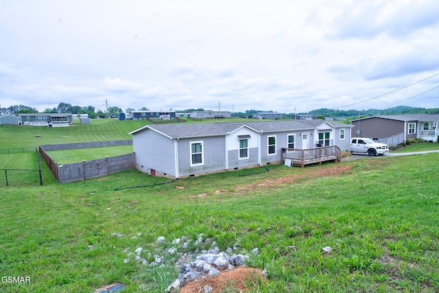 rear view of house featuring crawl space and a deck