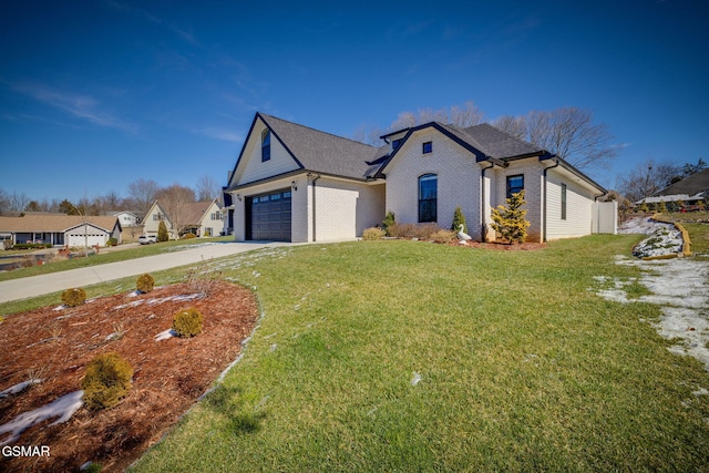 view of front of property featuring an attached garage, brick siding, driveway, a residential view, and a front lawn