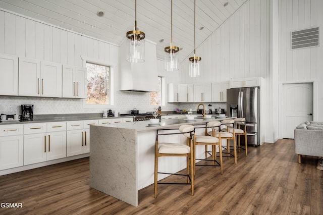 2931 Redtail Rd, Sevierville, TN 37862 - kitchen featuring high vaulted ceiling, stainless steel fridge with ice dispenser, dark wood finished floors, and visible vents