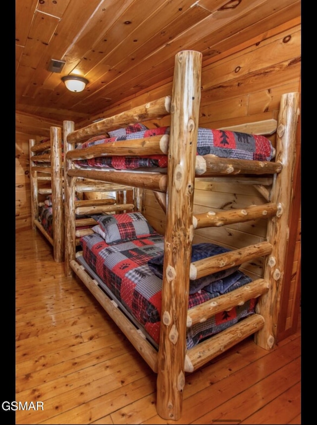 bedroom with hardwood / wood-style flooring and wood ceiling