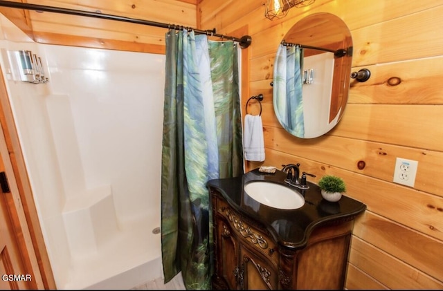 bathroom featuring a shower with curtain, wood walls, and vanity