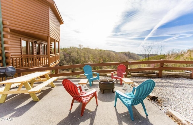 view of patio / terrace featuring an outdoor fire pit