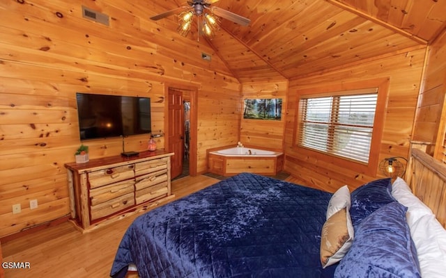 bedroom featuring wooden walls, light hardwood / wood-style flooring, lofted ceiling, and wood ceiling