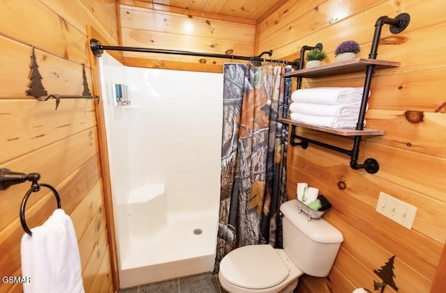 bathroom featuring a shower with shower curtain, tile patterned flooring, wood walls, and toilet