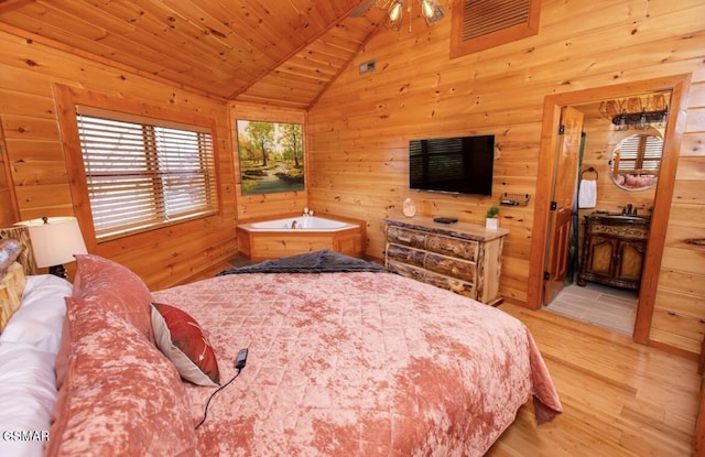 bedroom featuring lofted ceiling, wood walls, wooden ceiling, and light hardwood / wood-style flooring