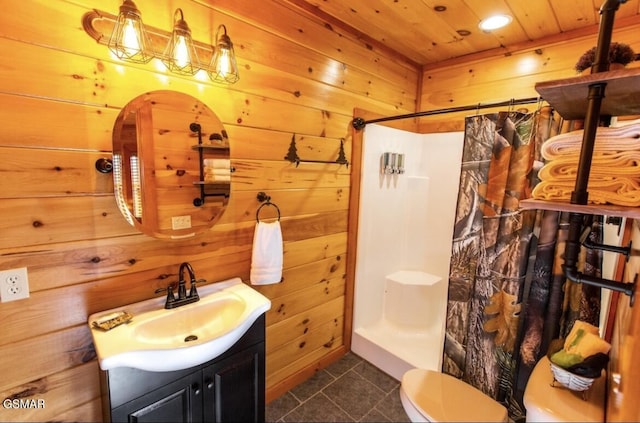 bathroom with vanity, tile patterned floors, curtained shower, and wooden walls