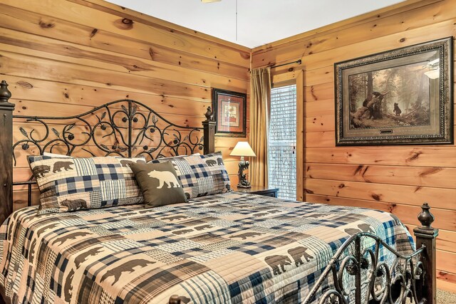 bedroom featuring wooden walls