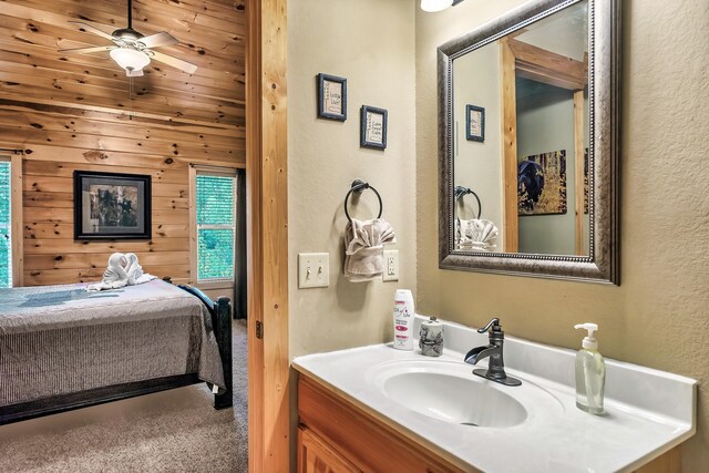 bathroom featuring wooden walls, vanity, and ceiling fan