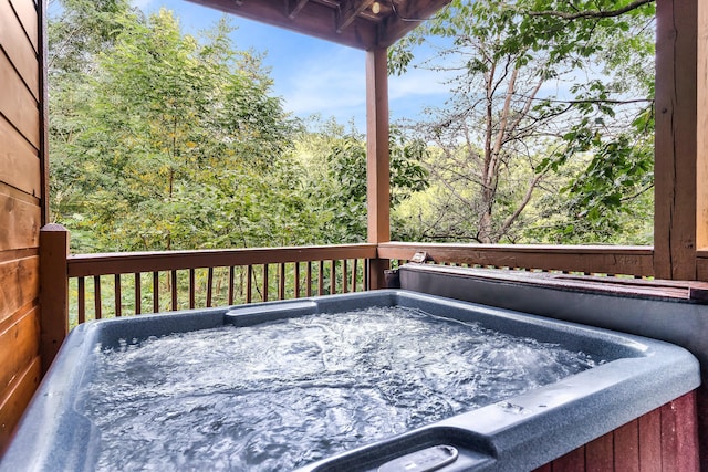 wooden deck featuring a hot tub