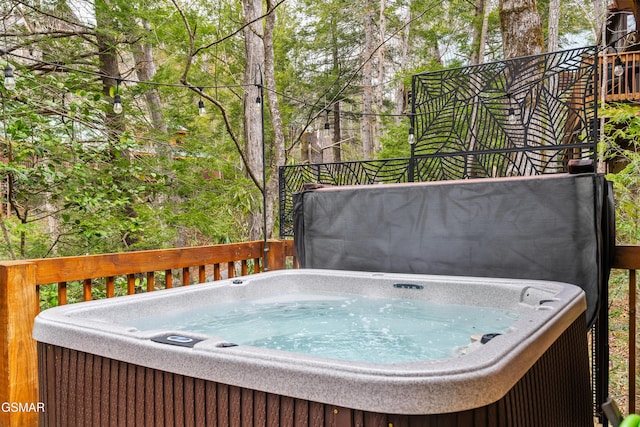 wooden deck with a hot tub