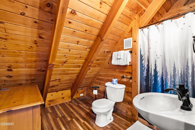 full bath featuring wooden walls, toilet, wooden ceiling, wood finished floors, and a sink