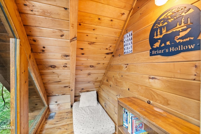 room details featuring visible vents, wood ceiling, and wood walls