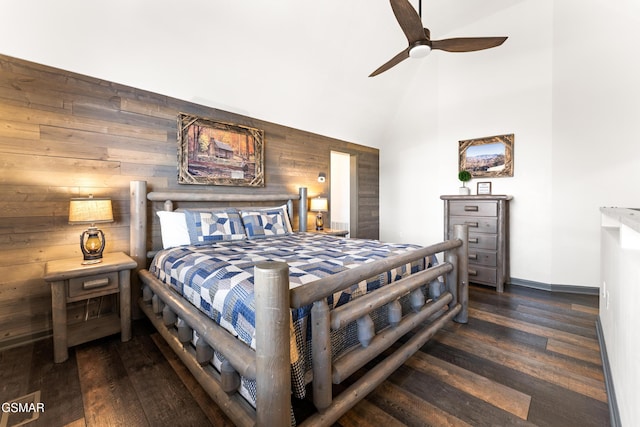 bedroom with high vaulted ceiling, wood walls, wood finished floors, a ceiling fan, and baseboards