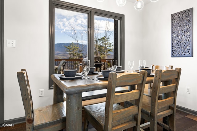 dining room with baseboards and a mountain view