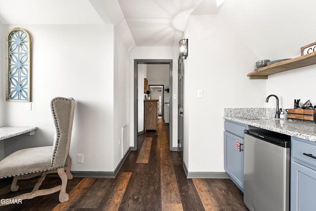 kitchen with dark wood-style floors, open shelves, light stone countertops, dishwasher, and fridge