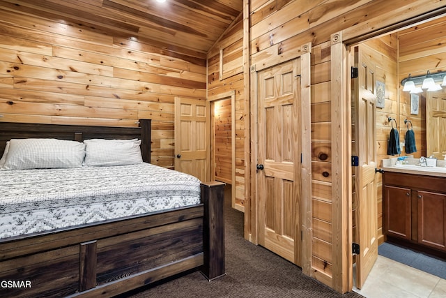 852 Resort Way, Gatlinburg, TN 37738 - bedroom featuring lofted ceiling, wood ceiling, wooden walls, a sink, and ensuite bath