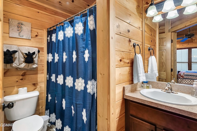 852 Resort Way, Gatlinburg, TN 37738 - bathroom featuring wood walls, vanity, toilet, curtained shower, and ensuite bathroom