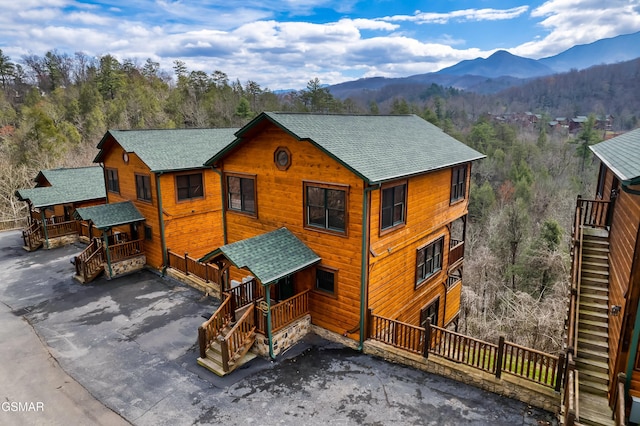 852 Resort Way, Gatlinburg, TN 37738 - rustic home featuring roof with shingles, a mountain view, stairs, and a forest view