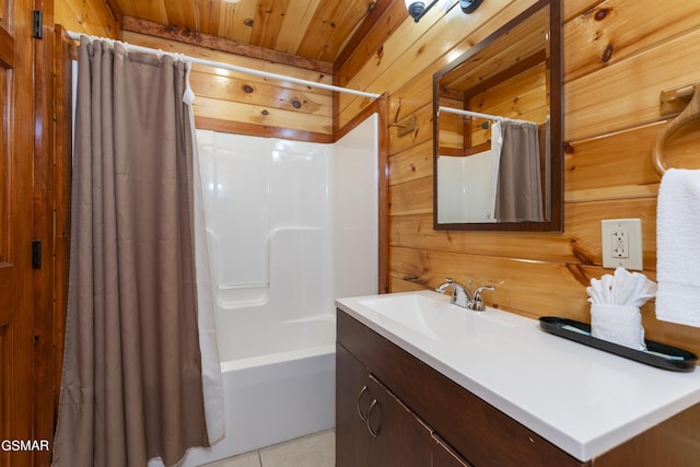 bathroom featuring wooden walls, shower / tub combo with curtain, vanity, and tile patterned flooring