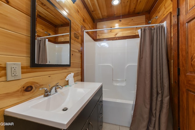 bathroom featuring shower / bath combination with curtain, vanity, tile patterned floors, and wooden walls