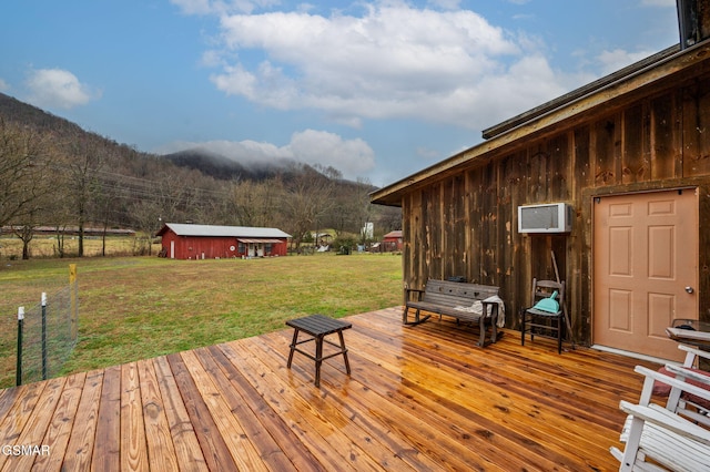 deck featuring a yard and a wall mounted AC