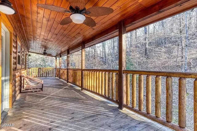 wooden deck featuring a ceiling fan and covered porch