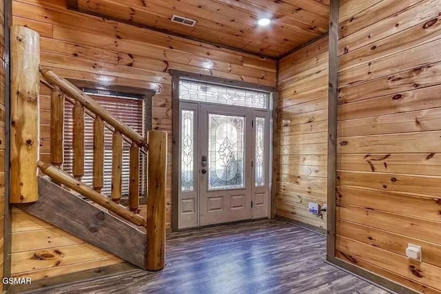 entrance foyer featuring wooden ceiling, wood finished floors, visible vents, and wood walls