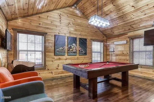 recreation room with wood walls and vaulted ceiling