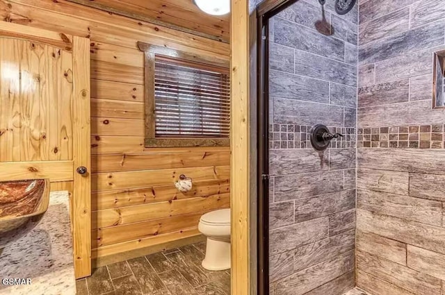 bathroom with tiled shower and toilet