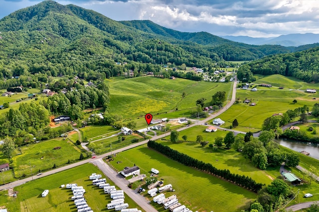 drone / aerial view featuring a water and mountain view