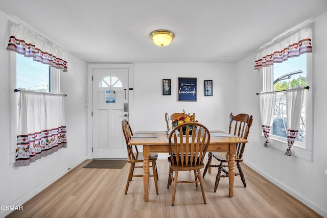 dining area with plenty of natural light and light hardwood / wood-style floors