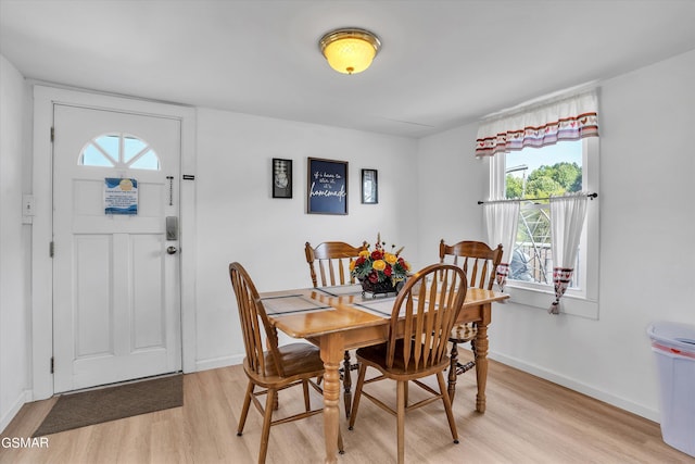 dining space with light hardwood / wood-style flooring