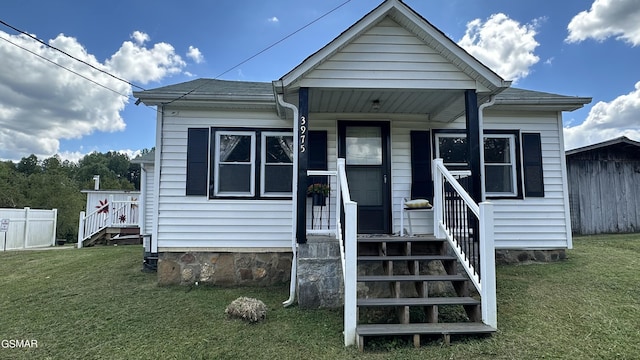 bungalow-style home featuring a front lawn