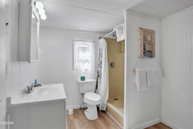 bathroom featuring hardwood / wood-style flooring, vanity, toilet, and walk in shower