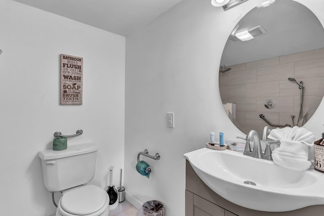 bathroom featuring tile patterned floors, vanity, and toilet