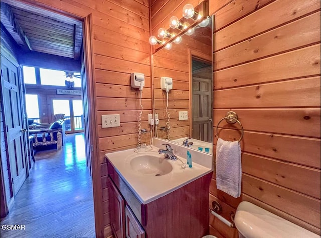 2438 Walnut Ridge Way, Sevierville, TN 37862 - bathroom with vanity, wooden walls, and wood finished floors