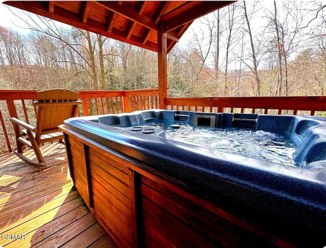 wooden deck with a hot tub