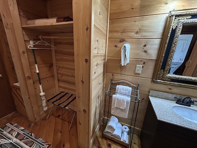 bathroom with wood walls and vanity