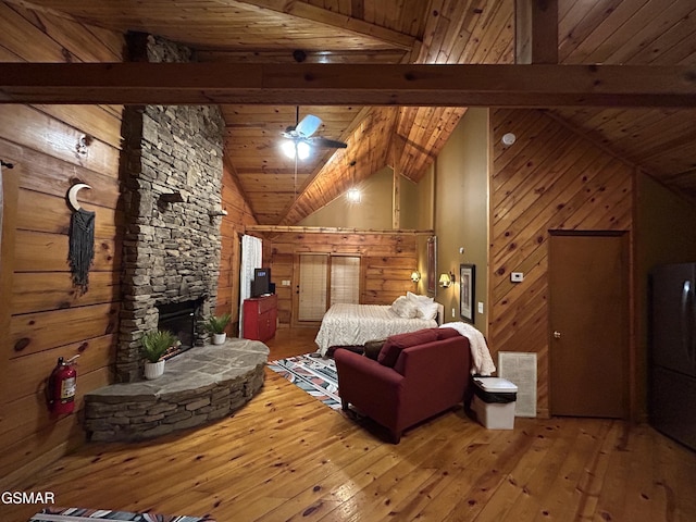 bedroom with wooden ceiling, wood walls, wood-type flooring, and beam ceiling