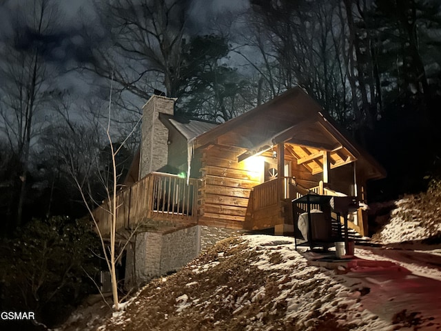 property exterior at twilight with a chimney