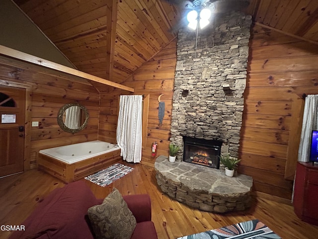 unfurnished living room featuring hardwood / wood-style floors, wooden ceiling, wood walls, and a fireplace
