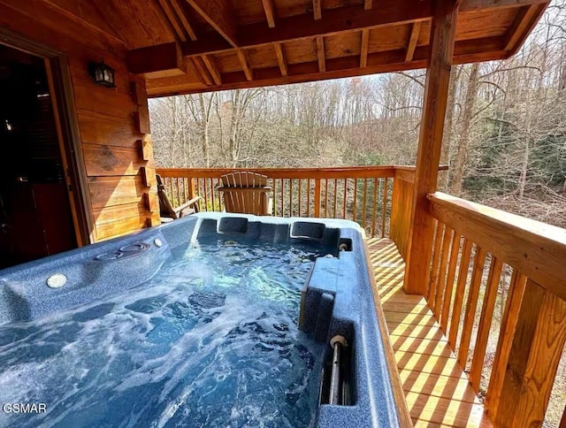 wooden terrace featuring a hot tub
