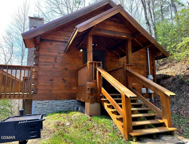 exterior space with log exterior and a chimney