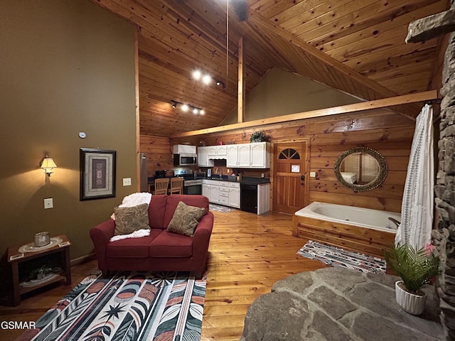 living room featuring wooden walls, high vaulted ceiling, light wood-style floors, and wood ceiling
