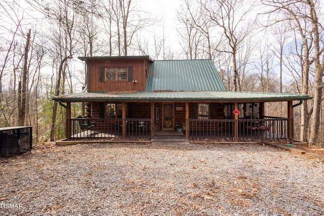 log-style house featuring covered porch