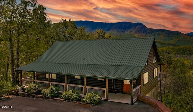 859 Pinnacle Vista Rd, Gatlinburg, TN 37738 - view of front of house with covered porch, a mountain view, a metal roof, and a forest view